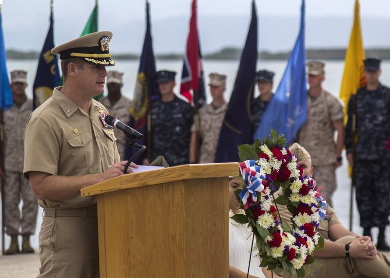 In this June 3, 2014, image provided by the U.S. Navy, Navy Capt. John R. Nettleton, then-commanding officer of Naval Station Guantanamo Bay, Cuba, speaks during a Battle of Midway commemoration ceremony. Nettleton was arrested Wednesday, Jan. 9, 2018, on charges that he interfered with the investigation into the death of a civilian with whom he fought after an argument over whether the officer had had an affair with the man's wife. (Mass Communication Specialist 3rd Class Jacob Goff/U.S. Navy via AP)