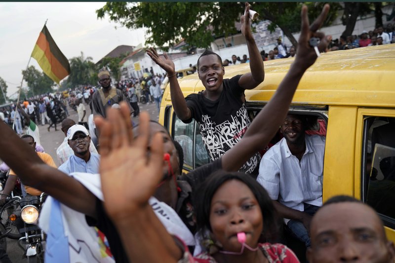 Supporters of opposition presidential candidate Felix Tshisekedi party outside his headquarters as they wait for election results to be released in Kinshasa, Congo, Wednesday Jan. 9, 2019. As Congo anxiously awaits the outcome of the presidential election, many in the capital say they are convinced that the opposition won and that the delay in announcing results is allowing manipulation in favor of the ruling party. (AP Photo/Jerome Delay)