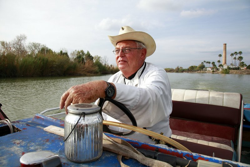 In this Tuesday, Jan. 8, 2019 photo, father Roy Snipes, pastor of the La Lomita Chapel, shows Associated Press journalists the land on either side of the Rio Grande at the US-Mexico border in Mission, Texas. Portions of Father Snipes' church land in Mission could be seized by the federal government to construct additional border wall and fence lines. Rather than surrender their land to the federal government, some property owners on the Texas border are digging in to fight President Donald Trump's border wall. They are rejecting buyout offers and preparing to battle the administration in court. Trump is scheduled to travel to the border Thursday to make the case for his $5.7 billion wall. (AP Photo/John L. Mone)