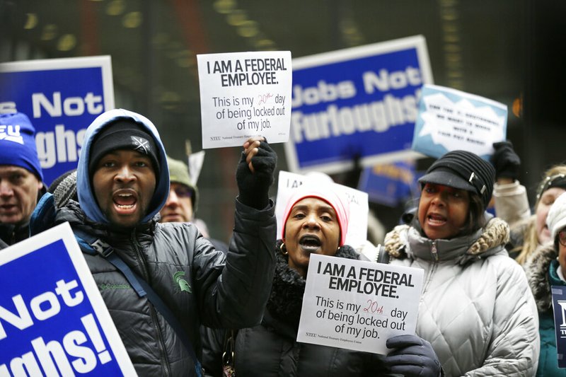 Government workers rally against the partial government shutdown at Federal Plaza, Thursday, Jan. 10, 2019, in Chicago. The partial government shutdown continues to drag on with hundreds of thousands of federal workers off the job or working without pay as the border wall fight persists. (AP Photo/Kiichiro Sato)