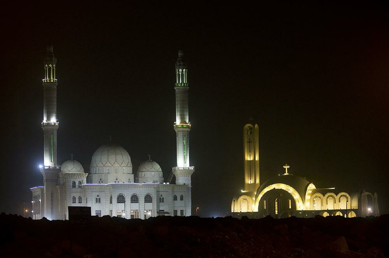 The “Great St. Antony Church” (right), and the Great mosque, are illuminated in Cairo on Sunday. The Coptic Christian population are considered to be the largest Christian community in the Middle East and observed Christmas on Monday according to the old, Julian calendar. 