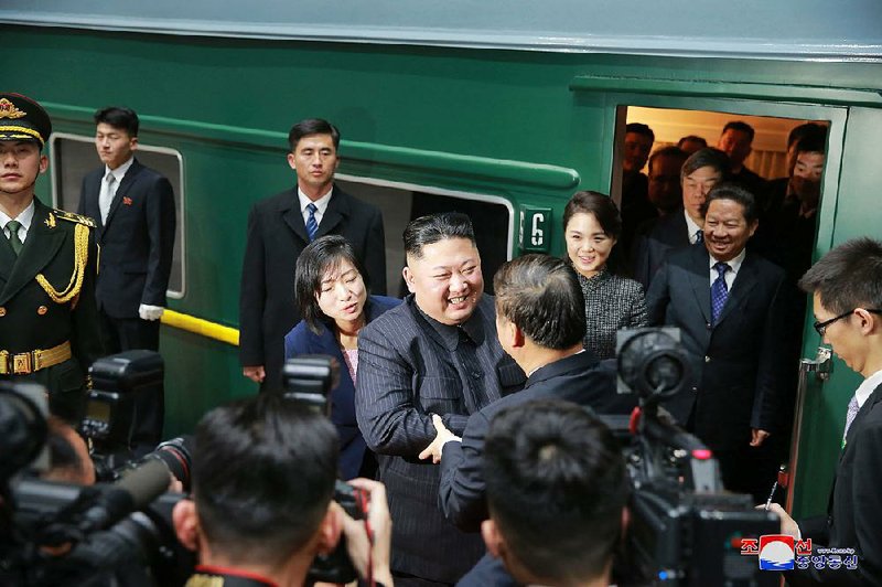 North Korean leader Kim Jong Un (center left) bids farewell to Chinese Communist Party’s International Department head Song Tao (center right) at a station in the Chinese border town of Dandong on Wednesday. 