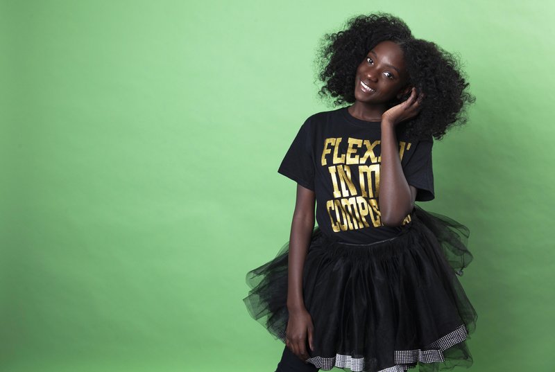 In this Dec. 19, 2018 photo, social media personality Kheris Rogers poses for a portrait in Los Angeles. Rogers launched her own fashion line with T-shirts sporting, &quot;Flexin' in My Complexion,&quot; along with backpacks reading &quot;The Miseducation of Melanin&quot; and other apparel and accessories. (Photo by Rebecca Cabage/Invision/AP)