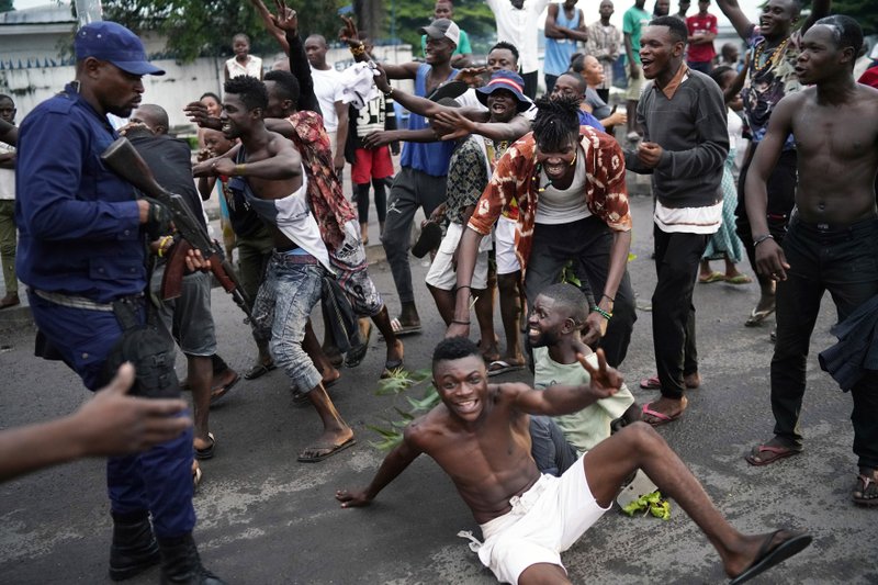 Residents celebrate in Kinshasa Thursday, Jan. 10, 2019, after learning that opposition presidential candidate Felix Tshisekedi had been declared the winner of the elections. (AP Photo/Jerome Delay)