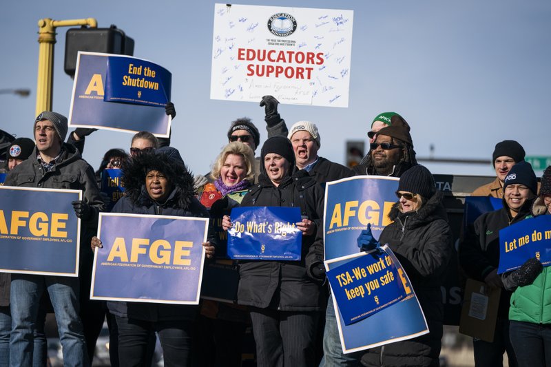 Government workers, American Federation of Government Employees union members and members of supporting local unions, pose for a group photo during the rally to highlight the effect the federal shutdown on Thursday in Minneapolis. (Leila Navidi/Star Tribune via AP)

