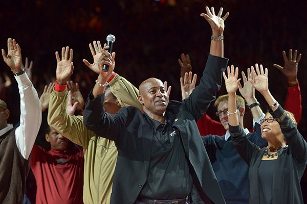 Former Arkansas basketball player Sidney Moncrief leads a Hog Call during halftime of a game between the Razorbacks and Mississippi State on Saturday, Feb. 7, 2015, in Fayetteville. 