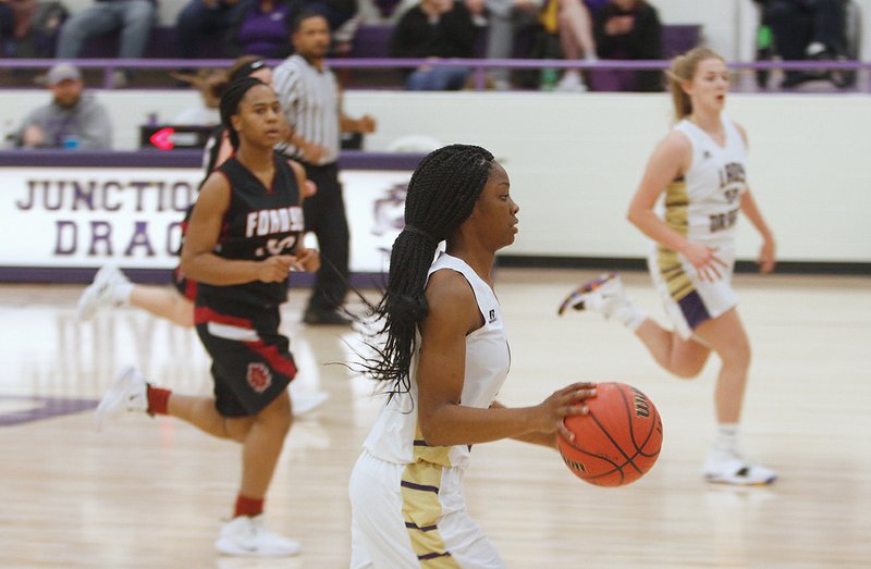 Terrance Armstard/News-Times Junction City's Taykeetria Rogers (5) brings the ball up the court during their game against Fordyce Thursday in Junction City.