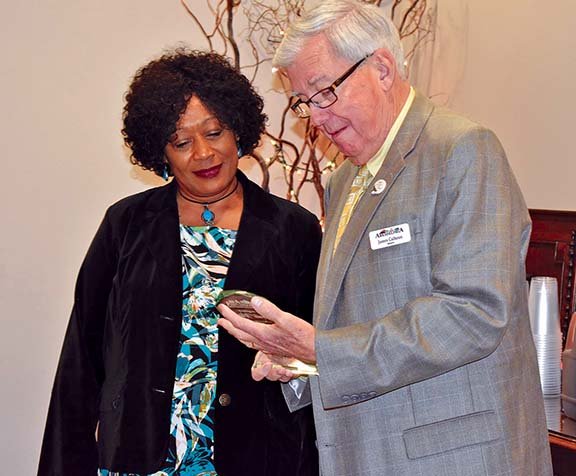 Arkadelphia Mayor James Calhoun, right, presents Anita Wiley with a plaque for her 21 years of service during a retirement celebration Nov. 27 at the Arkadelphia Town Hall. Wiley retired from the city of Arkadelphia on Dec. 31 after serving as supervisor of the Building Department. She was the city’s first African-American department head.