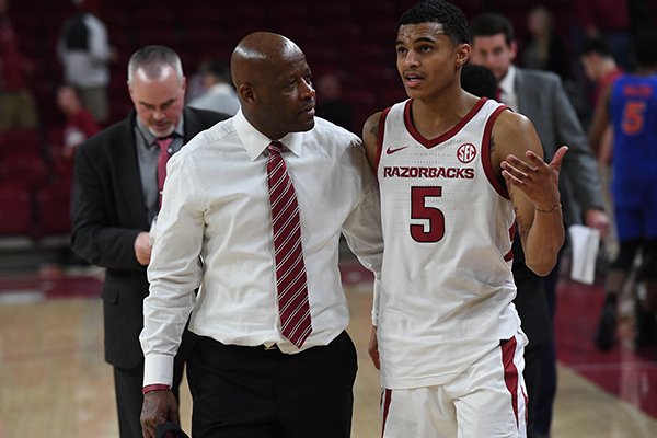 Arkansas coach Mike Anderson (left) walks off the floor with guard Jalen Harris (right) following a 57-51 loss to Florida on Wednesday, Jan. 9, 2019, in Fayetteville. 