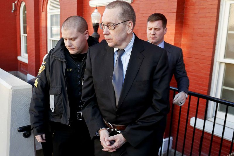 David Lee Poulson (center), a Roman Catholic priest who pleaded guilty to sexually abusing two boys, is taken away from court after sentencing Friday in Brookville, Pa. 