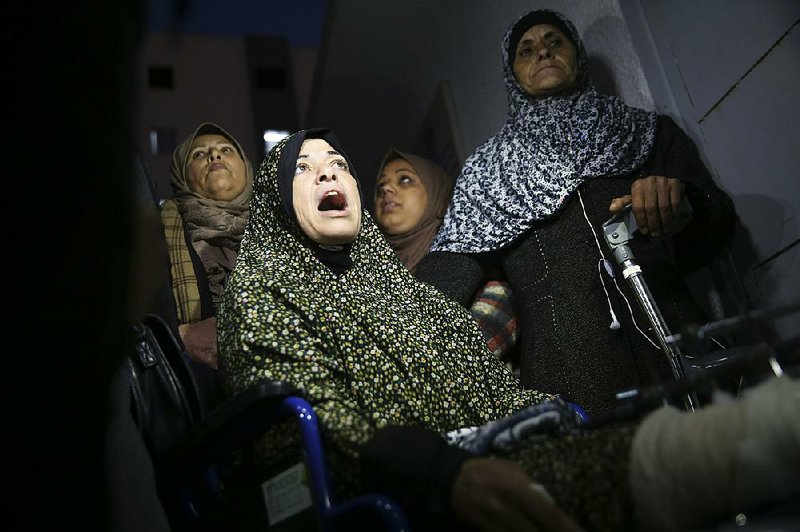 Relatives mourn Friday in front of the morgue of Shifa hospital in  Gaza City while waiting to see the body of a woman who was  shot  and killed by Israeli troops during a protest at the Gaza Strip’s border with Israel. 