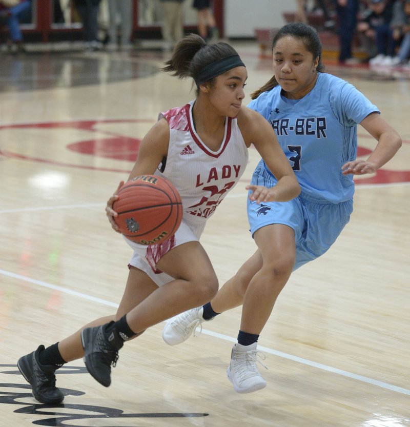 NWA Democrat-Gazette/ANDY SHUPE Springdale's QuaNeishia Bohanon (left) drives to the lane as she is guarded by Springdale Har-Ber's Flo Karu (3) Friday, Jan. 11, 2019, during the first half of play in Bulldog Gymnasium in Springdale. Visit nwadg.com/photos to see more photographs from the games.