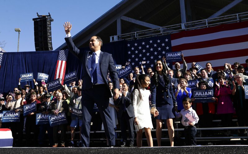 Former San Antonio Mayor and Housing and Urban Development Secretary Julian Castro, front left, waves as he arrives with his family to an event where he announced his decision to seek the 2020 Democratic presidential nomination, Saturday, Jan. 12, 2019, in San Antonio. 