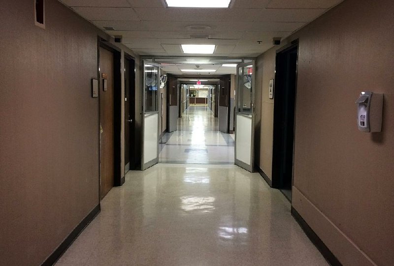 A hallway in the De Queen Medical Center shows no sign of activity Tuesday, with many doors shut tight and the cafeteria closed. 