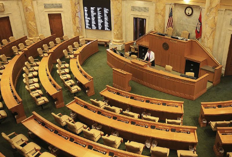 Parliamentarian Barrett Dudley works in the House Chamber at the state Capitol on Friday during preparations for Monday’s opening of the 92nd General Assembly. 