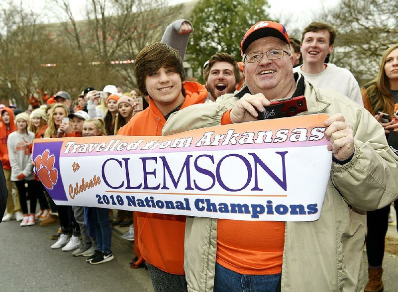 Jerry Halsell (right) and grandson Nick Oliver traveled from Paragould to Clemson, S.C., to attend Saturday’s parade held to honor Clemson’s football  team, which defeated Alabama on Monday in the national championship game. 