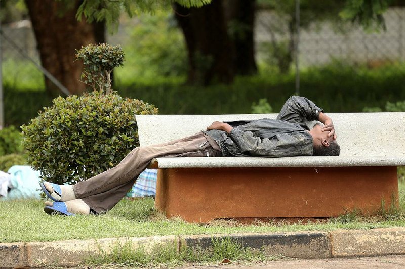 A man lies outside a government hospital Wednesday in Harare, Zimbabwe, after being turned away because of the doctors strike. 