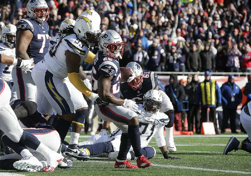 New England Patriots running back Sony Michel scores in front of Los Angeles Chargers defensive tackle Darius Philon (Arkansas Razorbacks) during the first half of Sunday’s AFC divisional play- off game in Foxborough, Mass. Michel ran for 129 yards and 3 touchdowns as the Patriots won 41-28.