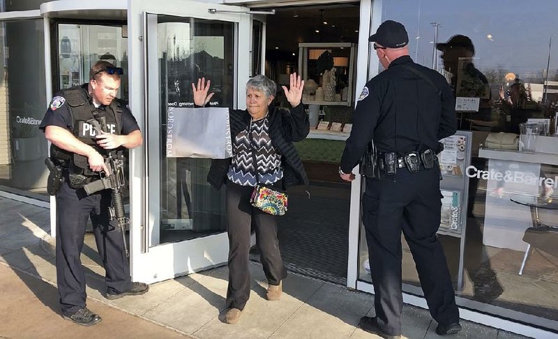 Shoppers are evacuated from the Fashion Place mall in Murray, Utah, after a shooting Sunday just outside the building. 