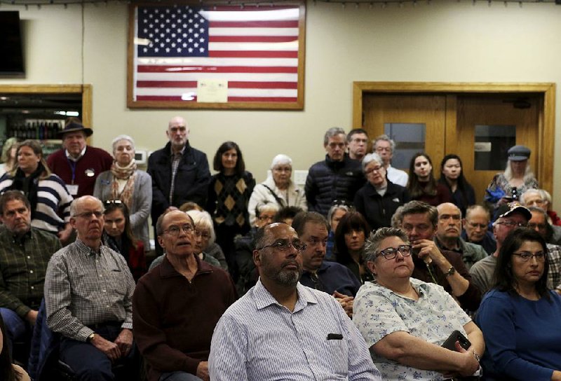 An audience at a VFW post in Wheaton, Ill., listens Sunday to Democratic Rep. Sean Casten discuss implications of the shutdown for government employees. Casten also addressed President Donald Trump’s efforts to build a border wall. 