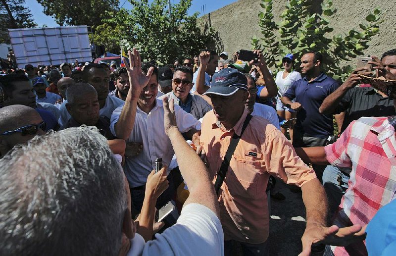 Juan Guaido, president of the Venezuelan National Assembly, greets supporters at a rally Sunday in northern Venezuela. 