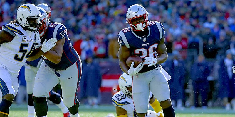 The Associated Press BRAND NAME: New England running back Sony Michel, right, heads for the goal line and his second touchdown Sunday during the first half of the Patriots' 41-28 win against the Los Angeles Chargers in the divisional round of the NFL playoffs in Foxborough, Mass.