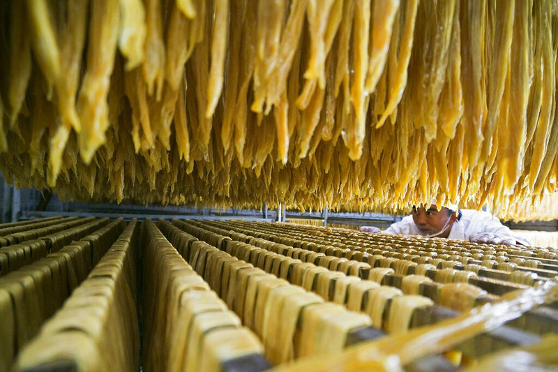 In this Jan. 10, 2019, photo released by Xinhua News Agency, a worker checks on a soybean food at a processing factory in Xiaotun Township of Dafang County in Bijie, southwest China's Guizhou Province. China's trade growth slowed in 2018 as a tariff battle with Washington heated up and global consumer demand weakened. Exports rose 7.1 percent, customs data showed Monday, Jan. 14, 2019 down from the 7.9 percent reported earlier for 2017. Import growth declined to 12.9 percent from the previous year's 15.9 percent. (Luo Dafu/Xinhua via AP)