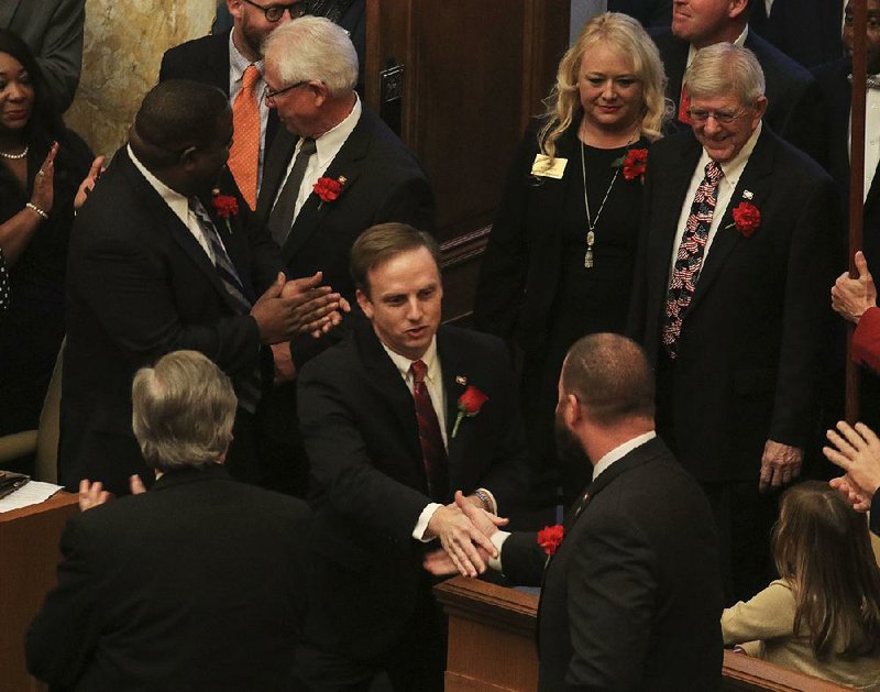 House Speaker Matthew Shepherd, R-El Dorado, greets members of the House on Monday as he arrives in the chamber to be sworn in on the first day of the legislative session. On the other side of the Capitol, Senate President Pro Tempore Jim Hendren, a Republican from Sulphur Springs, also was sworn in.