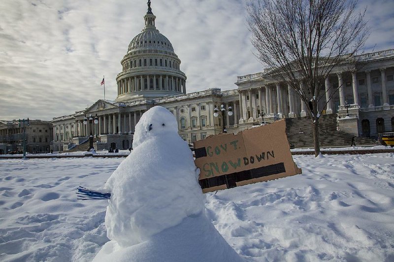 A snowman with a message is seen at the Capitol in Washington on Monday, the 24th day of a partial government shutdown.