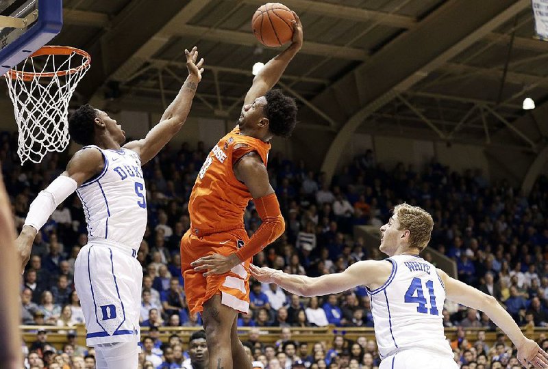 RJ Barrett (5) of Duke tries to stop Syracuse’s Elijah Hughes (33) from dunking in the Orange’s 95-91 overtime victory over the No. 1-ranked Blue Devils. Hughes scored 20 points in the victory.