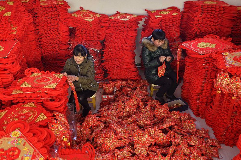Women make blessing decorations for the Feb. 5 Lunar New Year in Xingtai County, China. 