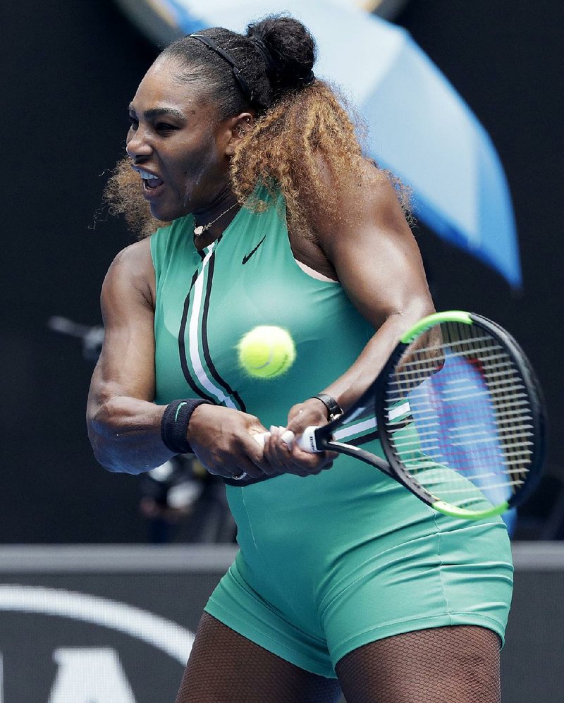Serena Williams hits a backhand return to Germany’s Tatjana Maria during their first-round match Monday at the Australian Open in Melbourne, Australia.