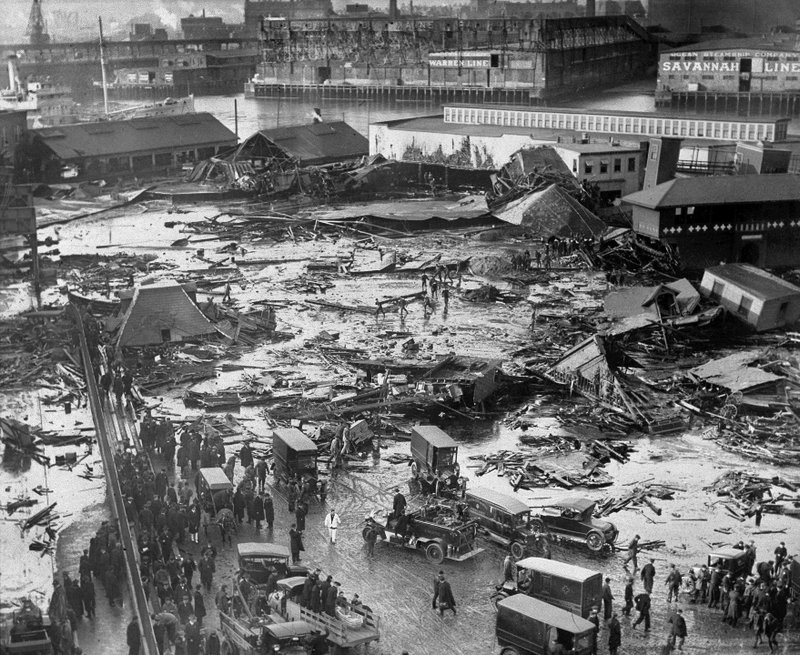 The Associated Press FAST AS MOLASSES: In this Jan. 15, 1919, file photo, the ruins of tanks containing more than 2 million gallons of molasses lie in a heap after erupting along the waterfront in Boston's North End neighborhood. Several buildings were flattened in the disaster, which killed 21 people and injured 150 others.