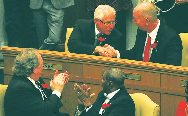 Arkansas Democrat-Gazette/Staton Breidenthal COZART CHAIRMAN: State Rep. Bruce Cozart, top right, R-District 24, of Hot Springs, shakes hands with Rep. Jon Eubanks, top left, of Paris, Monday after Eubanks was named speaker pro-tem of the House during the first day of the legislative session. Cozart was named chairman of the House Education Committee.