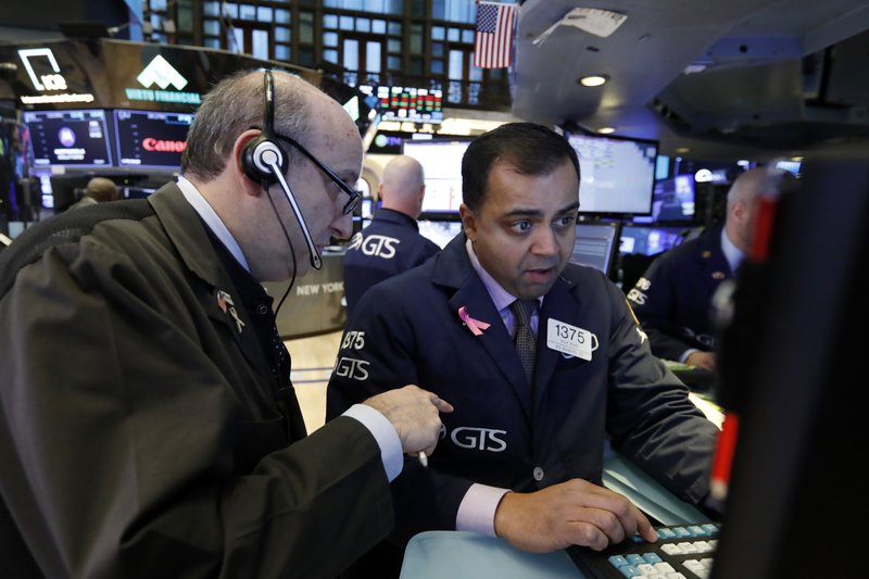 Trader Andrew Silverman, left, and specialist Didlip Patel work on the floor of the New York Stock Exchange, Monday, Jan. 14, 2019. Stocks are opening lower on Wall Street after China reported a surprise drop in exports to the U.S. last month. (AP Photo/Richard Drew)