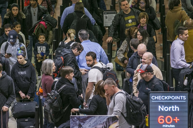 Air travelers endured waits of more than an hour to get through domestic checkpoints at Hartsfield-Jackson International Airport in Atlanta amid the partial federal shutdown Monday morning, Jan. 14, 2019. No-shows among screeners across the nation soared Sunday and again Monday, the first business day after TSA agents missed paychecks for the first time due to the partial government shutdown that began on Dec. 22. (John Spink/Atlanta Journal-Constitution via AP)