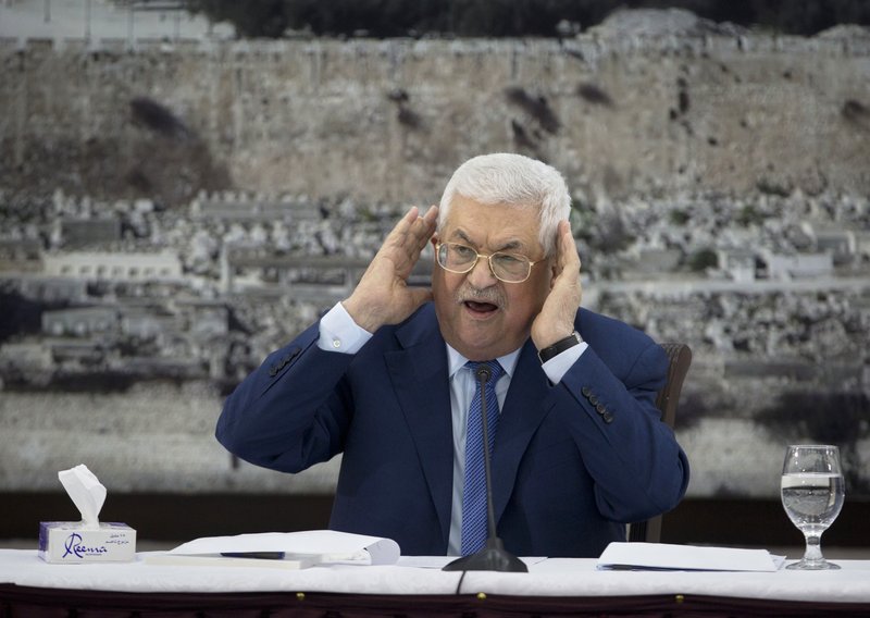 FILE - In this Dec. 22, 2018 file photo, Palestinian President Mahmoud Abbas gestures as he speaks during a meeting of the Palestinian leadership in the West Bank city of Ramallah. The Western-backed Palestinian Authority is threatening to step up pressure on Hamas amid renewed tensions in Gaza, even as Israel allows a lifeline of Qatari aid to flow directly to the Islamic militants. Abbas wants to reassert his authority over Gaza, while Israeli Prime Minister Benjamin Netanyahu seeks to preserve calm ahead of April's elections. (AP Photo/Majdi Mohammed, File)