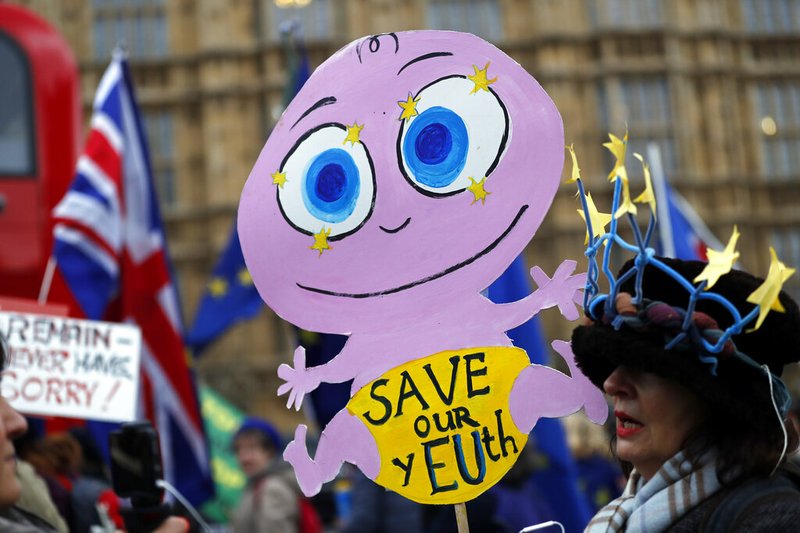 Pro-European demonstrators protest opposite the Houses of Parliament in London, Tuesday, Jan. 15, 2019. Britain's Prime Minister Theresa May is struggling to win support for her Brexit deal in Parliament. Lawmakers are due to vote on the agreement Tuesday, and all signs suggest they will reject it, adding uncertainty to Brexit less than three months before Britain is due to leave the EU on March 29. (AP Photo/Frank Augstein)