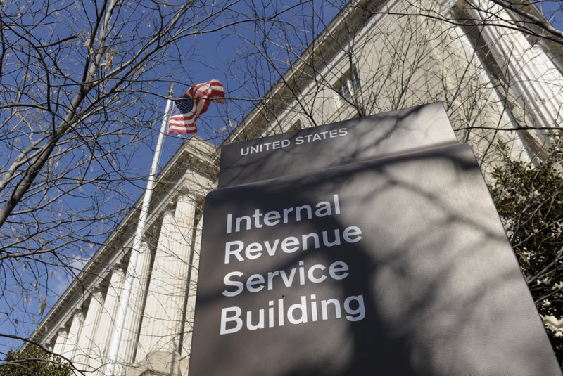 This March 22, 2013 file photo, shows the exterior of the Internal Revenue Service building in Washington. The Internal Revenue Service is recalling about 46,000 of its employees furloughed by the government shutdown, nearly 60 percent of its workforce, to handle tax returns and pay out refunds. The employees won't be paid. (AP Photo/Susan Walsh, File)

