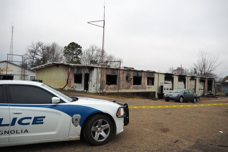 A Magnolia Police unit sits at the scene of an early morning Tuesday fire that destroyed Yeller Hawk Wrecker Service at 414 W. Union Street in Magnolia. 