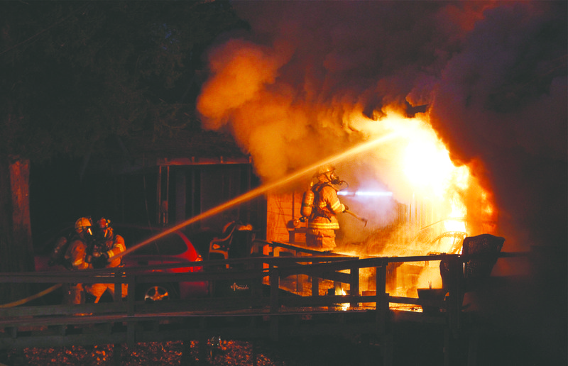 El Dorado firefighters battle a blaze at a house at 826 Russell Ave. on Tuesday.