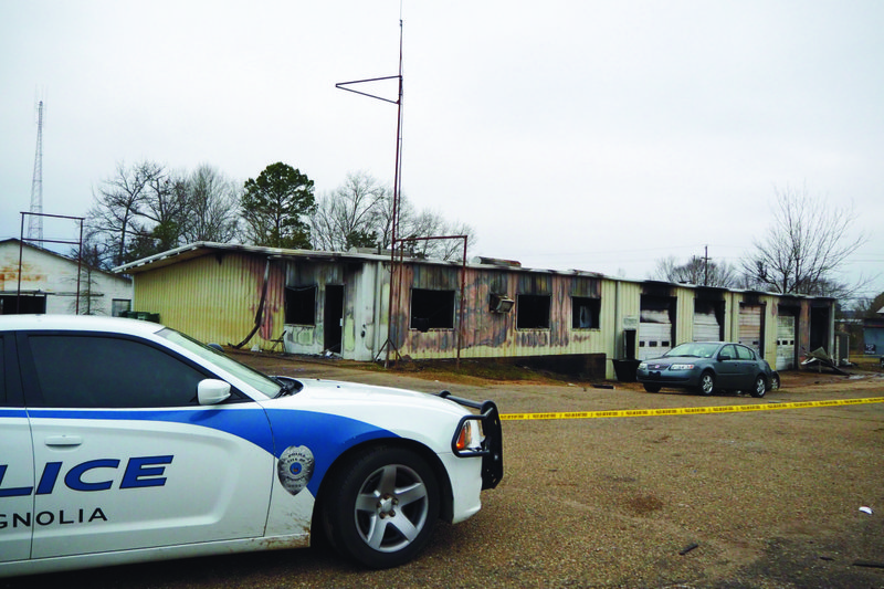 A Magnolia Police unit sits at the scene of an early morning Tuesday fire that destroyed Yeller Hawk Wrecker Service at 414 W. Union Street in Magnolia.