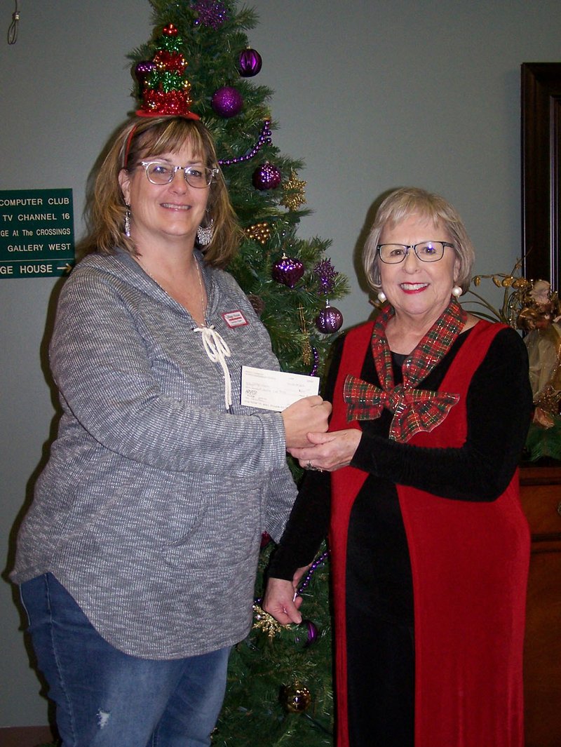 Photo submitted Perfect Harmony Women's Barbershop Chorus, in keeping with its commitment to give back to the community, recently gave The Village House of Bella Vista a donation of $200. Carolyn Fliger (left) accepts the check from baritone singer Barb Compton. The chorus meets at 4 p.m. every Monday at the United Lutheran Church in Bella Vista.