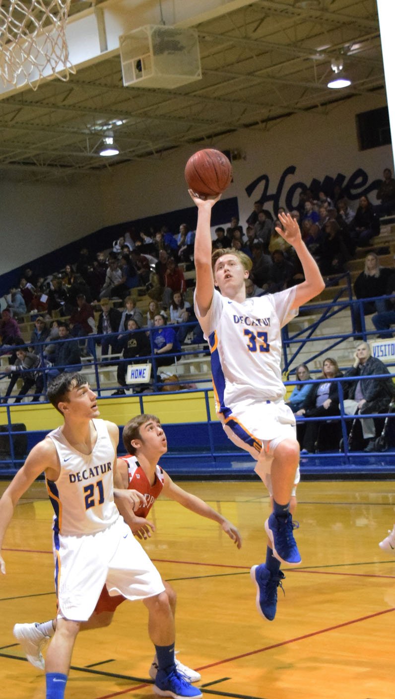 Westside Eagle Observer/MIKE ECKELS

Cayden Bingham (Decatur 21) blocks a Bobcat as team mate Conner Sutton (Decatur 33) goes for a layup during the Decatur-Flippin conference matchup at Peterson Gym in Decatur Jan 11.