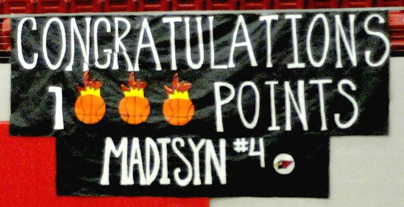MARK HUMPHREY ENTERPRISE-LEADER This banner commemorating 1,000 career points scored in Lady Cardinal uniform by Farmington senior Madisyn Pense hung in Cardinal Arena during Farmington's 56-34 conference win over Gentry on Tuesday, Jan. 8, 2019. Pense accomplished the feat a month earlier making a 3-point field goal and adding a free-throw to convert a 4-point play against Pea Ridge on Dec. 18, 2018.