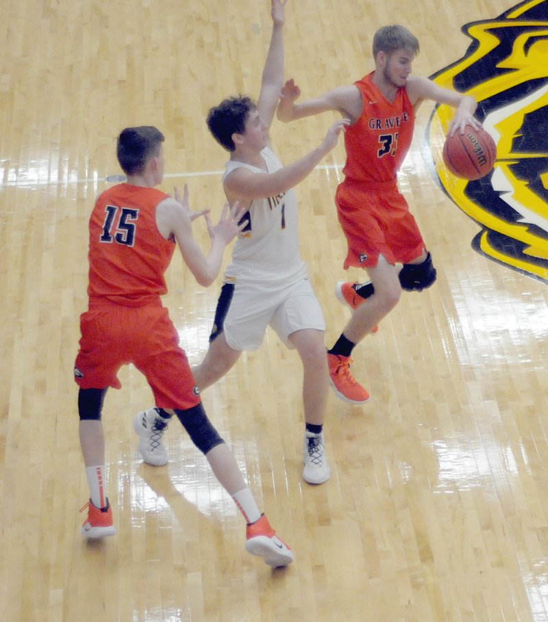 MARK HUMPHREY ENTERPRISE-LEADER/Gravette junior Brayden Trembly steals a pass by Prairie Grove point-guard Braden Reisner during a double-team with sophomore Tristan Batie. Prairie Grove beat the Lions 43-42 on a last-second shot at Tiger Arena on Tuesday, Jan. 8, 2019.