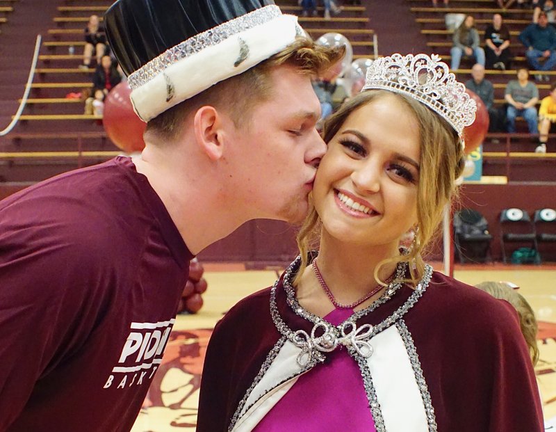 Westside Eagle Observer/RANDY MOLL Gentry High School senior Dylan Kilgore, chosen coronation king, kisses Gentry senior Madison Ward after she was crowned coronation queen during special ceremonies at Gentry High School on Friday night (Jan. 11, 2019).