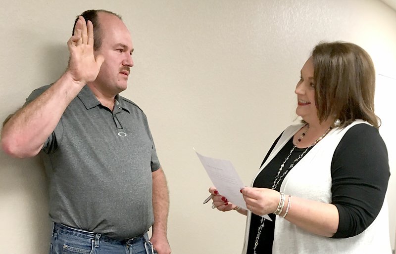 Westside Eagle Observer/RANDY MOLL Ryan Evans is sworn in to the Ward 3, Position 2, council post by Mayor Michelle Rieff after being appointed to fill the vacant position by the Highfill City Council on Jan. 8.