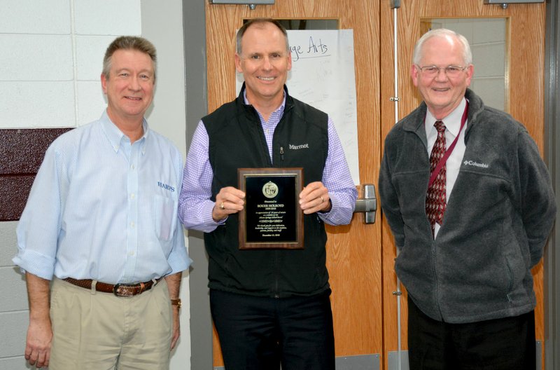 Janelle Jessen/Herald-Leader School board president Brian Lamb, left, and Superintendent Ken Ramey, right, presented Roger Holroyd, center, with a plaque on Thursday honoring him for his service to the Siloam Springs School Board. Holroyd formally announced his resignation from the board during Thursday's meeting after nearly 10 years on the board.