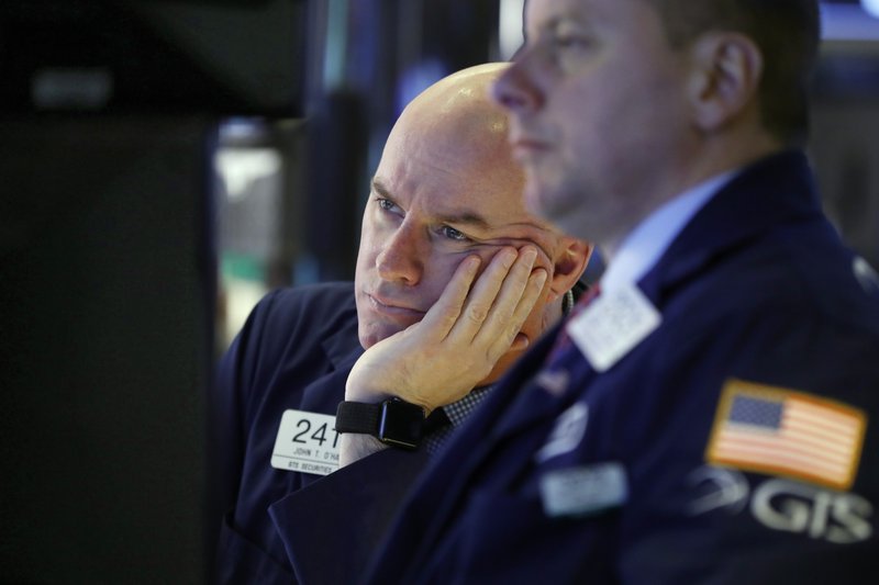 In this Jan. 11, 2019, file photo, Specialist John O'Hara, left, works on the floor of the New York Stock Exchange. (AP Photo/Richard Drew, File)